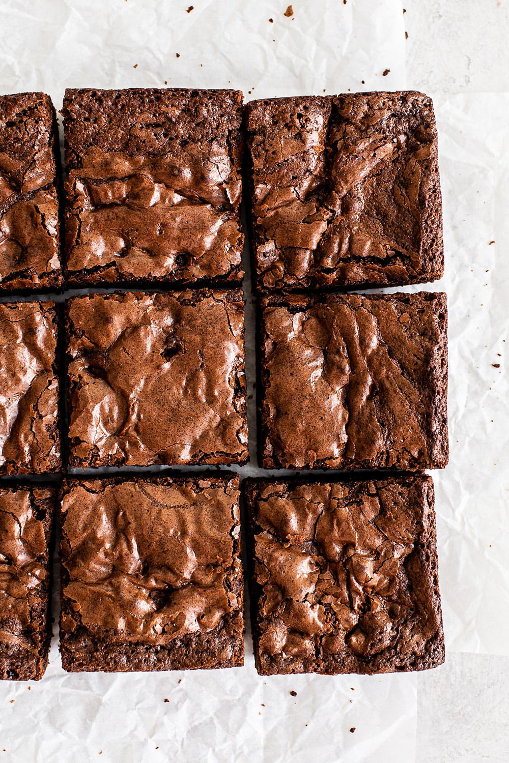 Ultra chewy brownies on parchment paper with crinkly crust on top. Better than box mix!