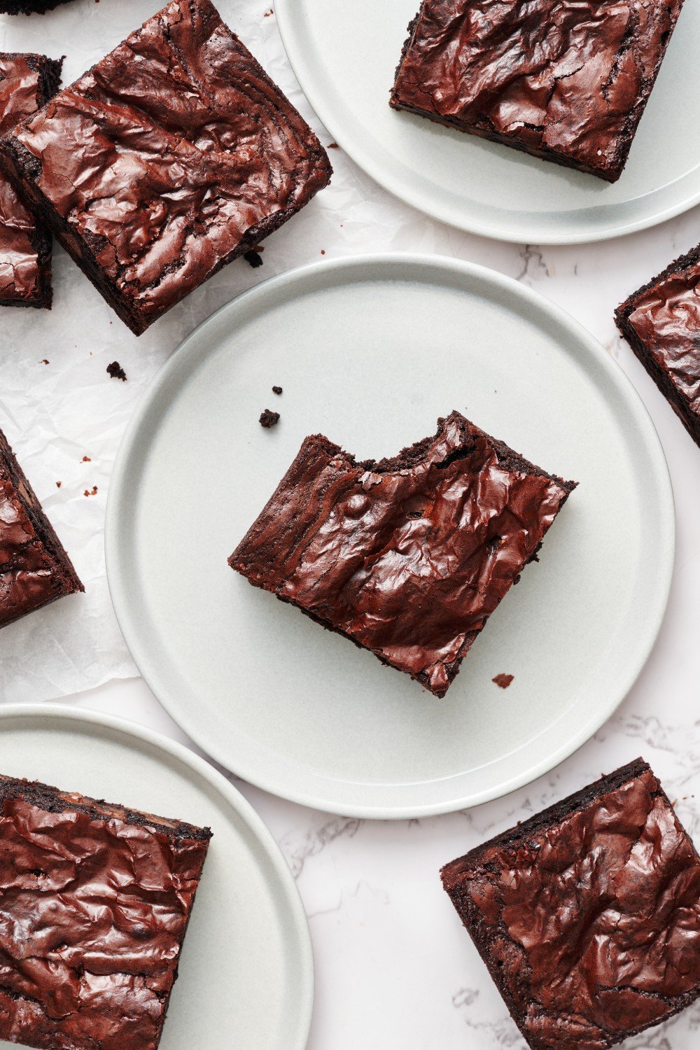slices of chewy brownies on white plates, ready to serve.