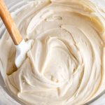easy homemade cream cheese frosting in a mixing bowl with a spatula