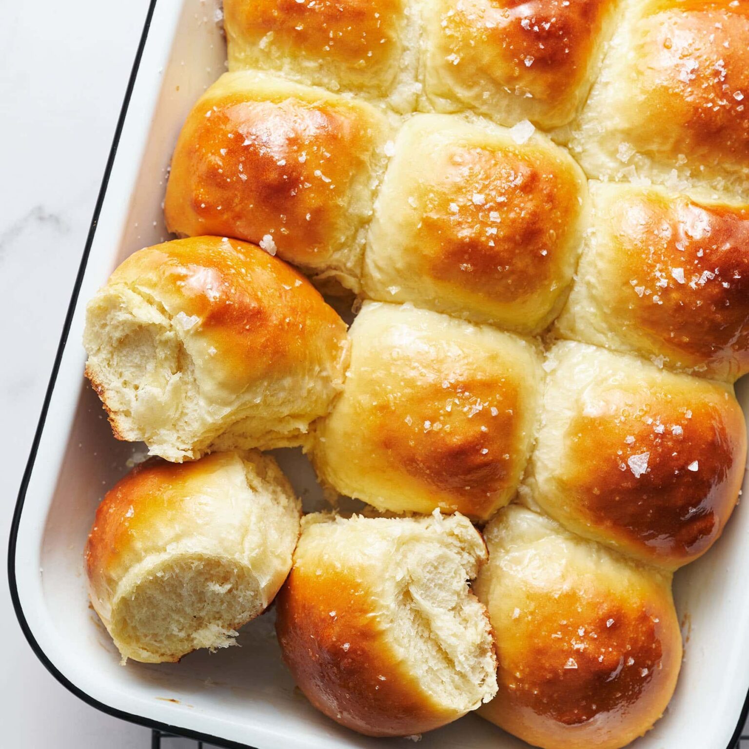 Tasty dinner rolls topped with garlic butter and salt.