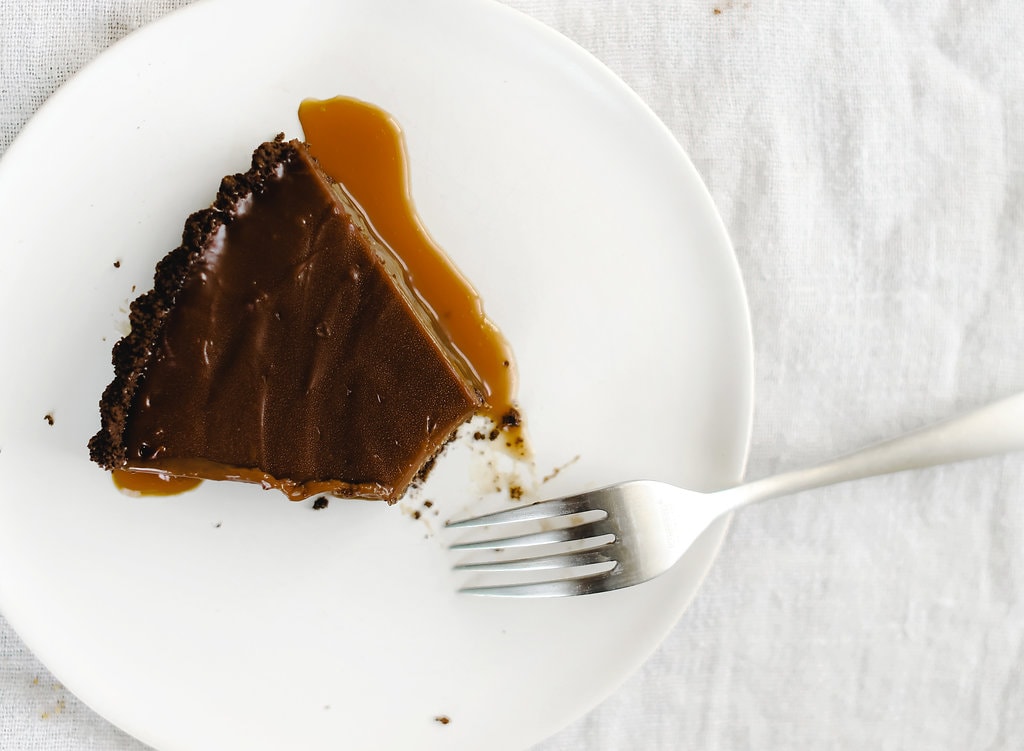 Nutella Caramel Tart features a chocolate graham cracker crust, a layer of hidden homemade salted caramel, and a rich Nutella fudge filling. Pure bliss!