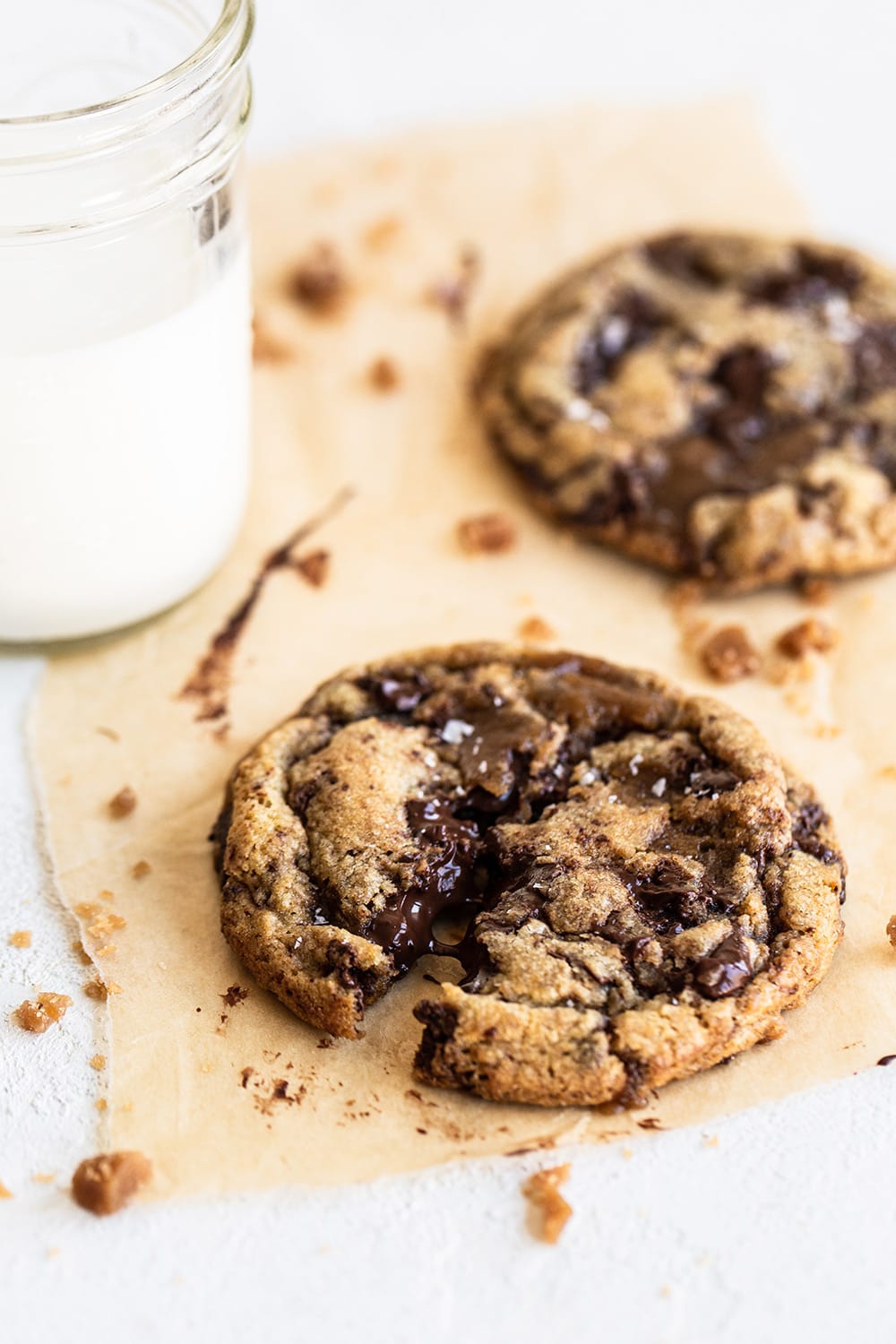 browned butter toffee chocolate chip cookies with glass of milk