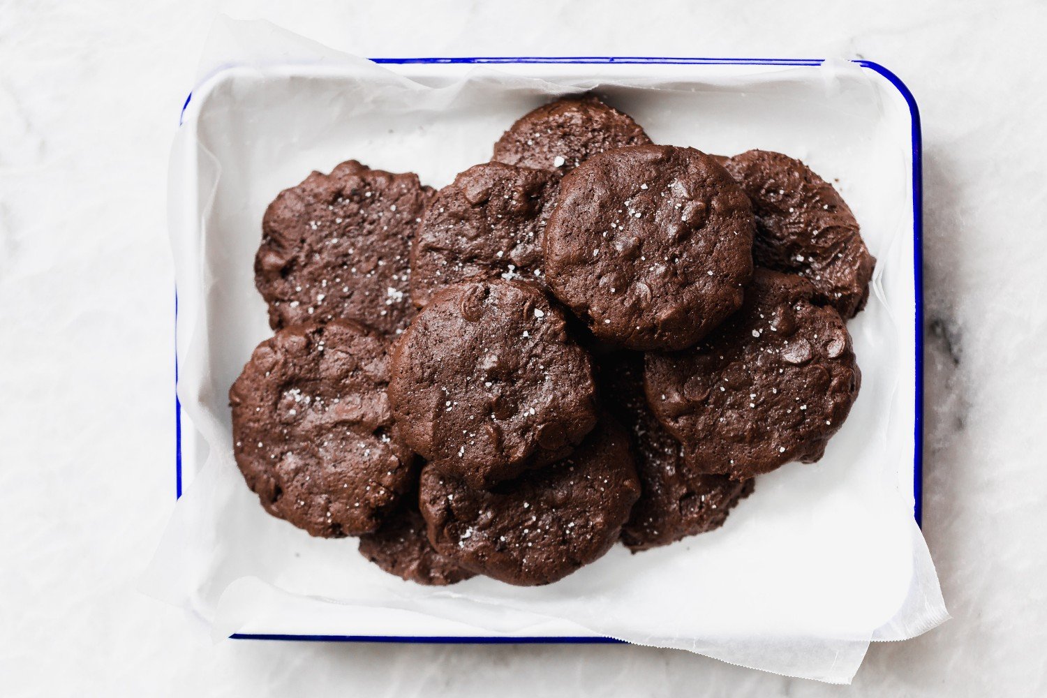 a container full of soft batch double chocolate chip cookies.