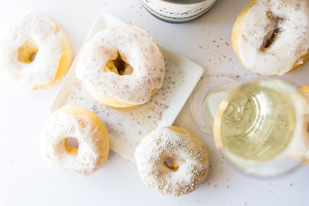 Baked Champagne Doughnuts are ultra light and fluffy. Made with champagne in the dough AND in the icing, these are perfect for any New Year's celebration.