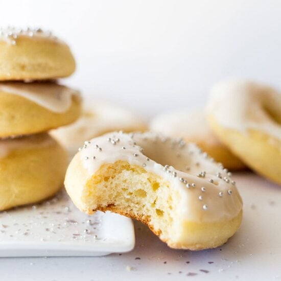 Baked Champagne Doughnuts are ultra light and fluffy. Made with champagne in the dough AND in the icing, these are perfect for any New Year's celebration.