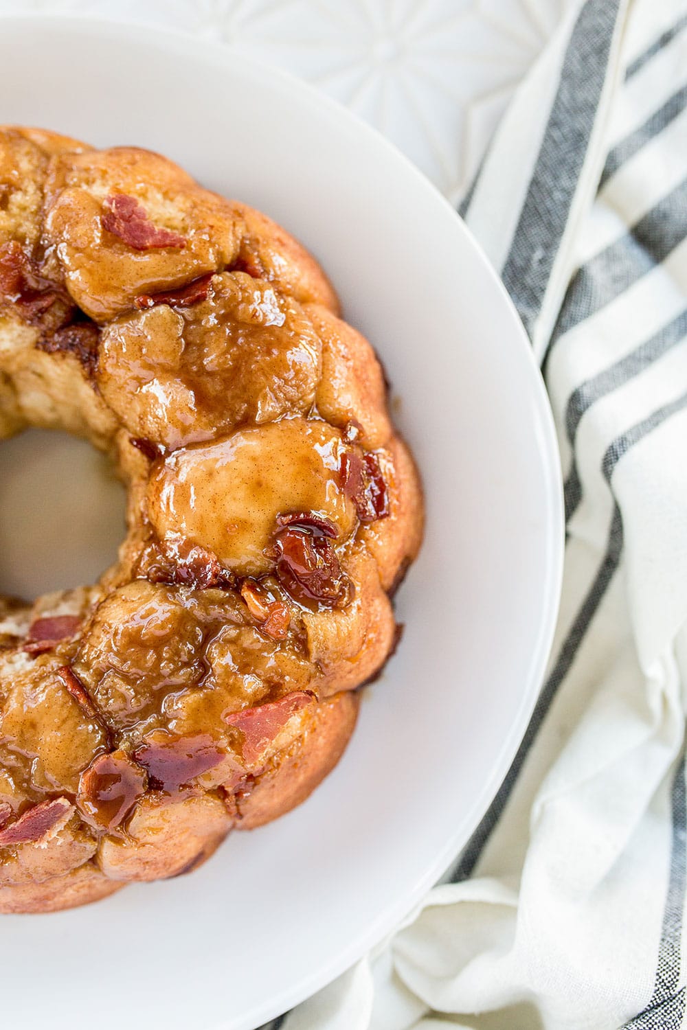 Insanely rich and gooey Maple Bacon Monkey Bread is loaded with sweet cinnamon, maple syrup, and tons of crisp bacon for the ultimate decadent treat.