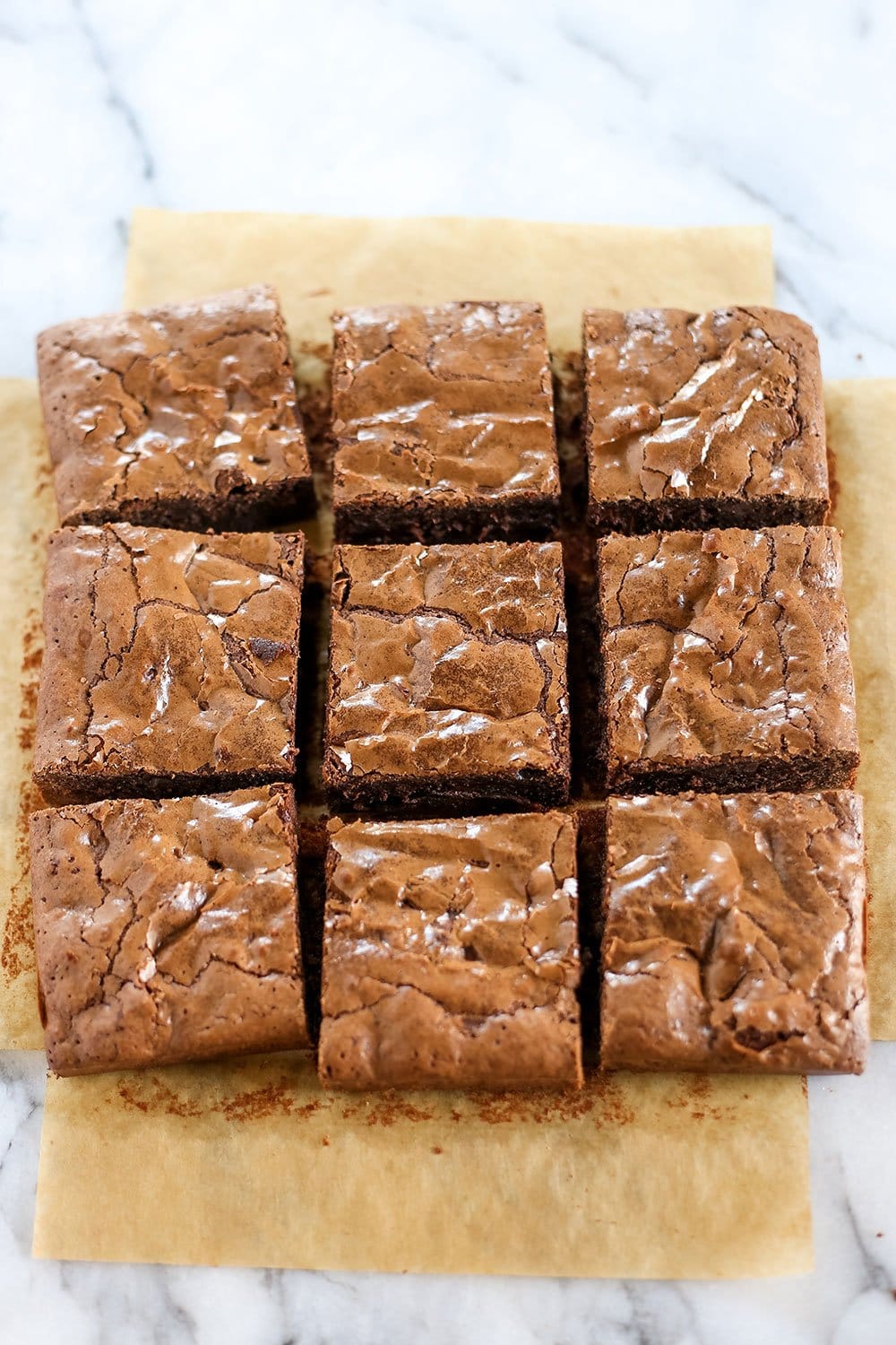 Best Easy Brownies require just 1 bowl, no mixer, and take less than an hour to make! They're tall, fudgy, and chewy with that thin shiny crust on top and tons of chocolate flavor.