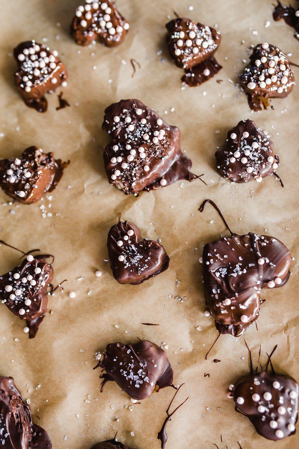 chocolate covered cookie dough hearts for Valentine's Day setting on parchment paper
