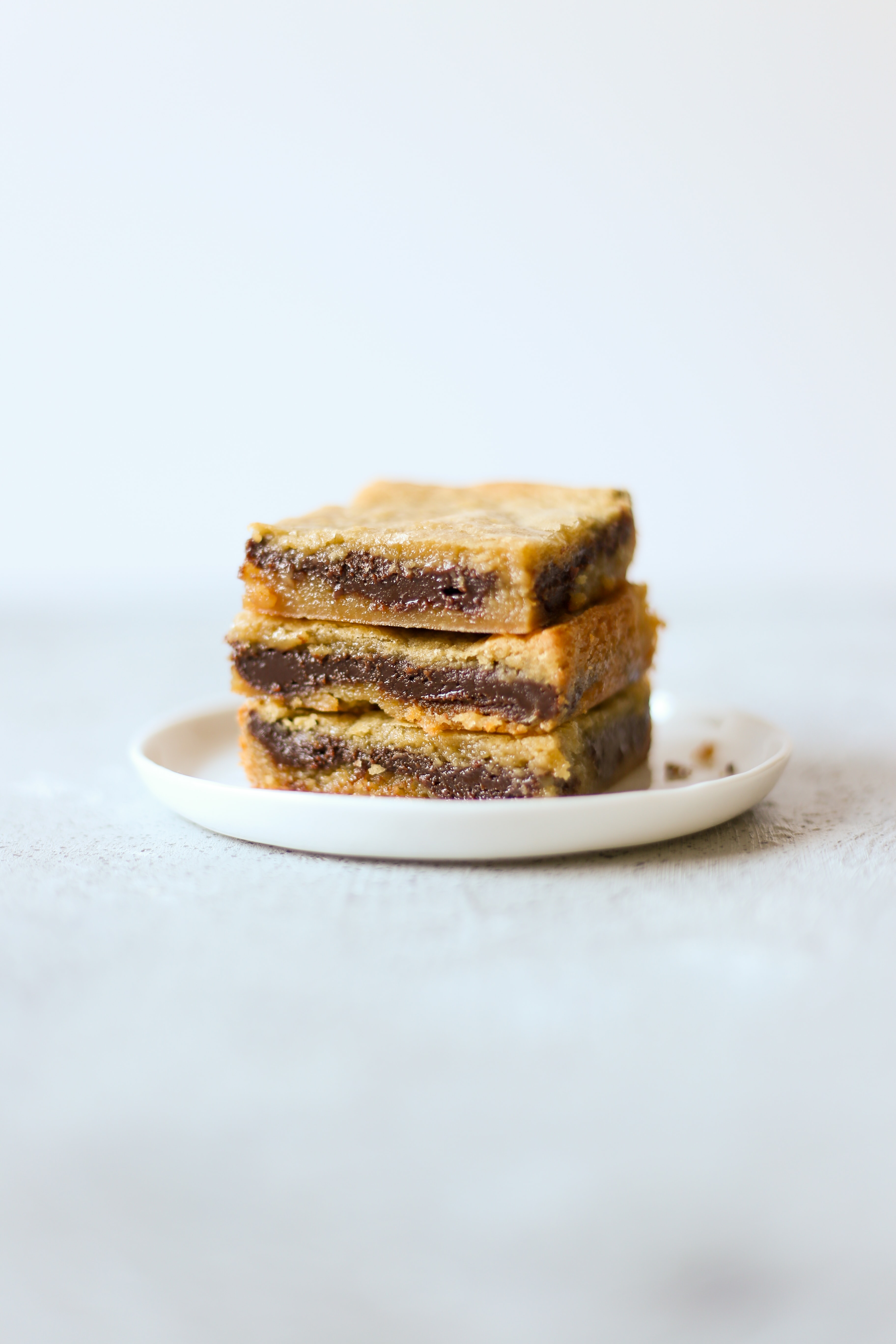 Fudge Filled Blondies are insanely rich and gooey with a hidden layer of easy chocolate fudge inside every bite! Simple 30 minute recipe.