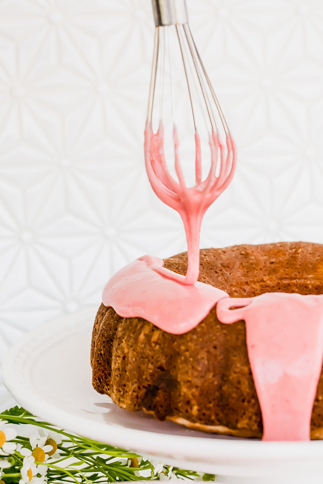 This light, fluffy, and flavorful Strawberry Bundt Cake is made with a fresh strawberry puree and absolutely no artificial colors or flavors! It's the perfect easy yet crowd-pleasing spring or summer cake.