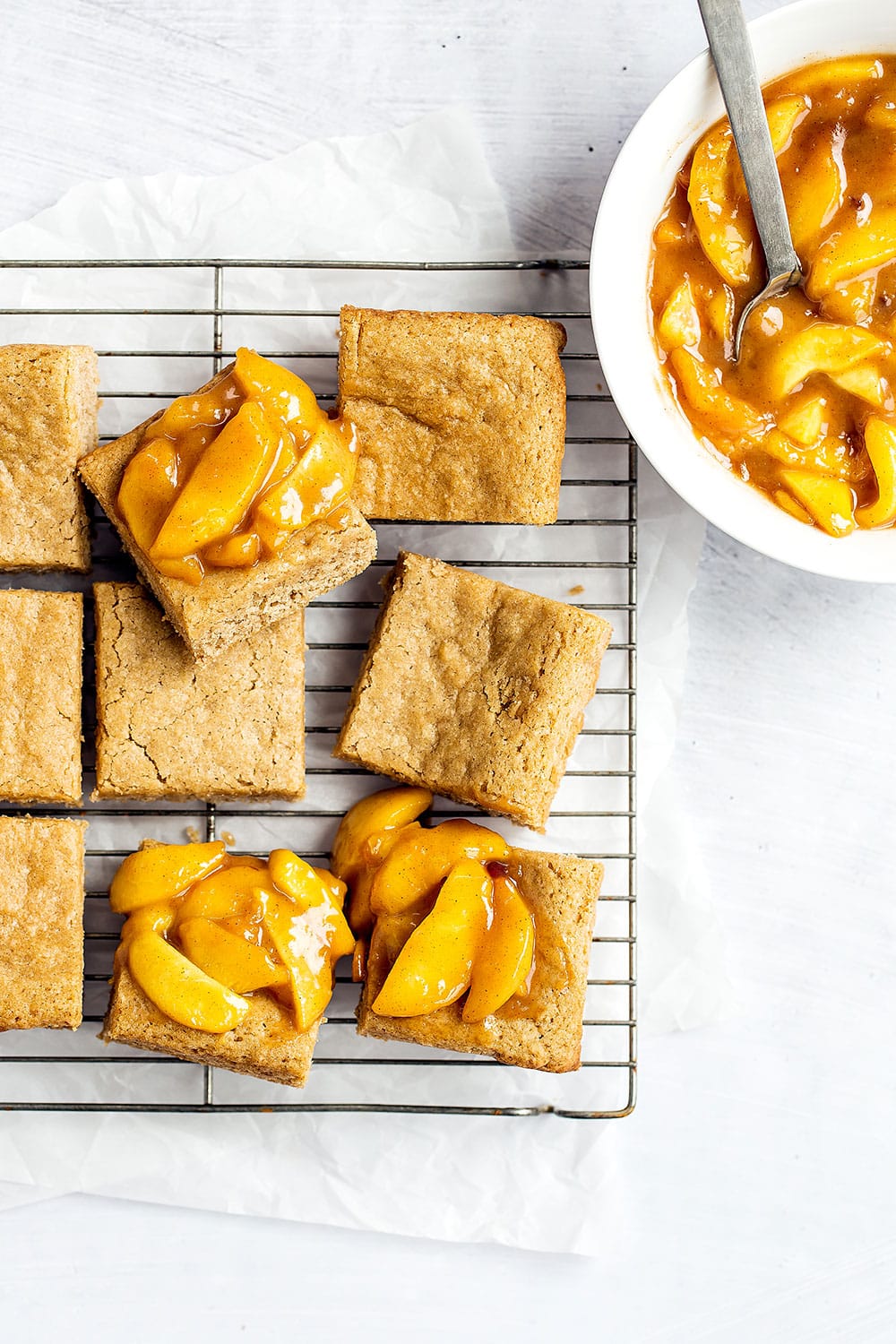 Caramel Peach Snickerdoodle Bars feature a chewy cinnamon cookie bar layer loaded with a homemade gooey caramel peach topping. 