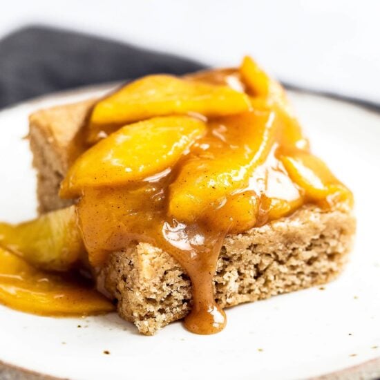 Caramel Peach Snickerdoodle Bars feature a chewy cinnamon cookie bar layer loaded with a homemade gooey caramel peach topping.