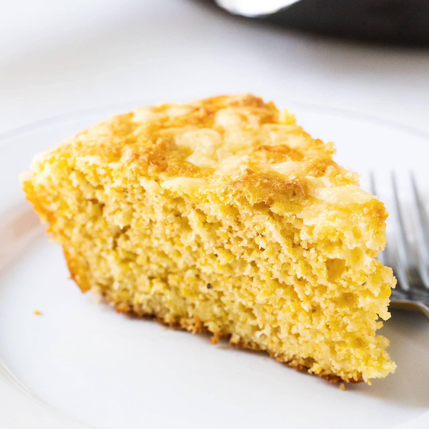 Cheesy Skillet Cornbread is ultra moist, tender, and loaded with cheddar cheese. It can be made in the oven or the grill, making it he perfect summer barbecue recipe!