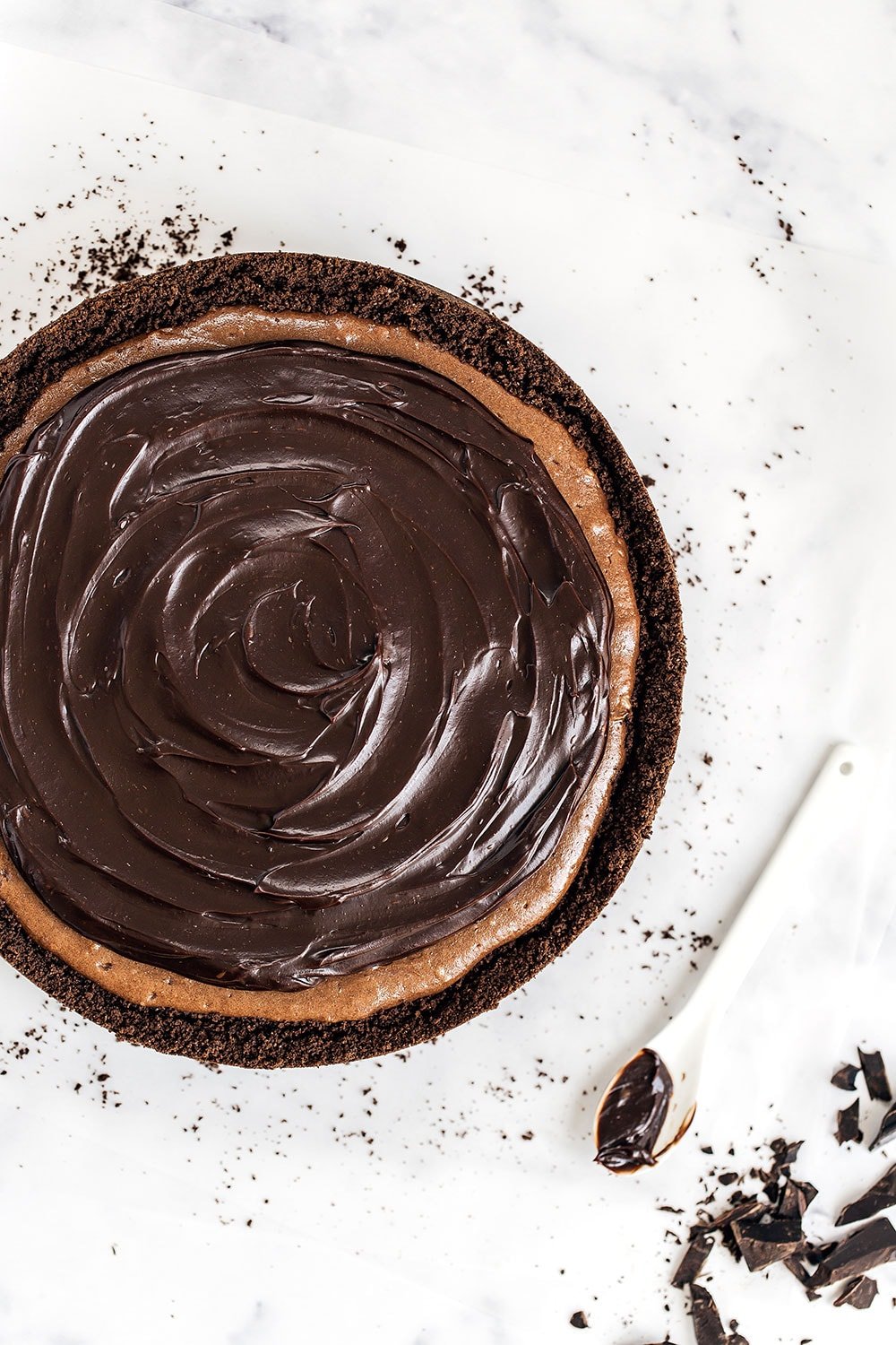 Insanely decadent Death by Chocolate Cheesecake features chocolate in FOUR forms: chocolate cookie crust, double chocolate cheesecake filling, with a chocolate ganache topping. It doesn't get better than this!