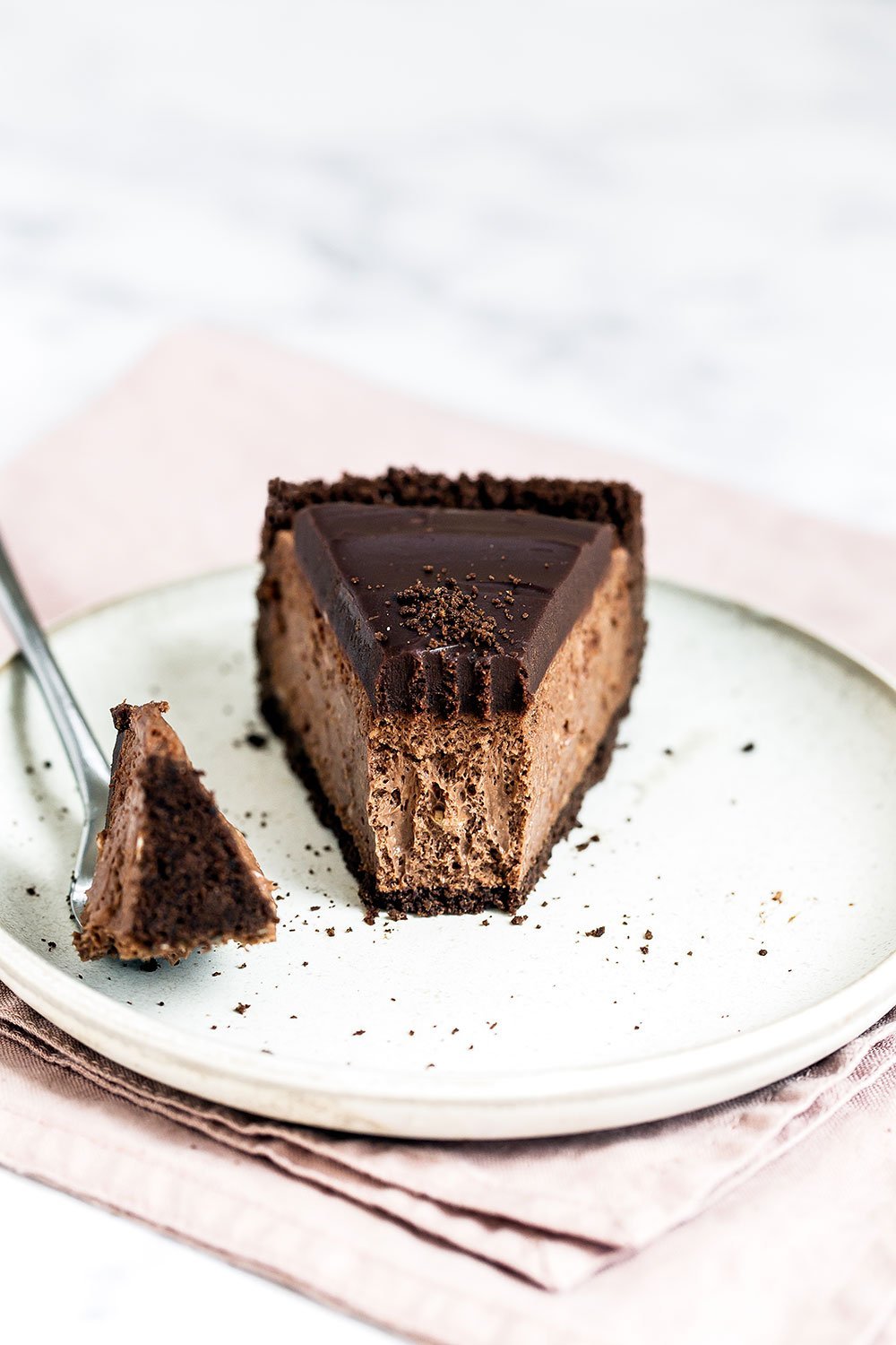 Insanely decadent Death by Chocolate Cheesecake features chocolate in FOUR forms: chocolate cookie crust, double chocolate cheesecake filling, with a chocolate ganache topping. It doesn't get better than this!