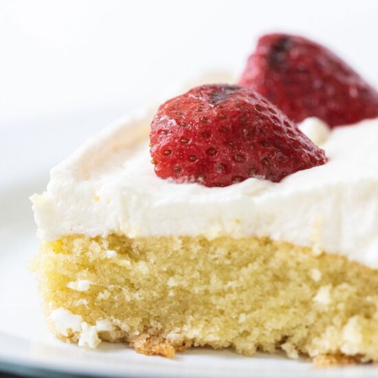 Vanilla Sheet Cake with Grilled Strawberries features an ultra moist, tender, and slightly spongy vanilla cake with fresh whipped cream and slightly smoky grilled strawberries on top. Perfect summer dessert for a crowd!