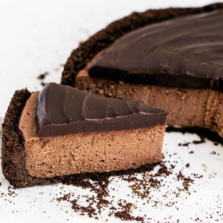 a slice being cut from the triple chocolate cheesecake