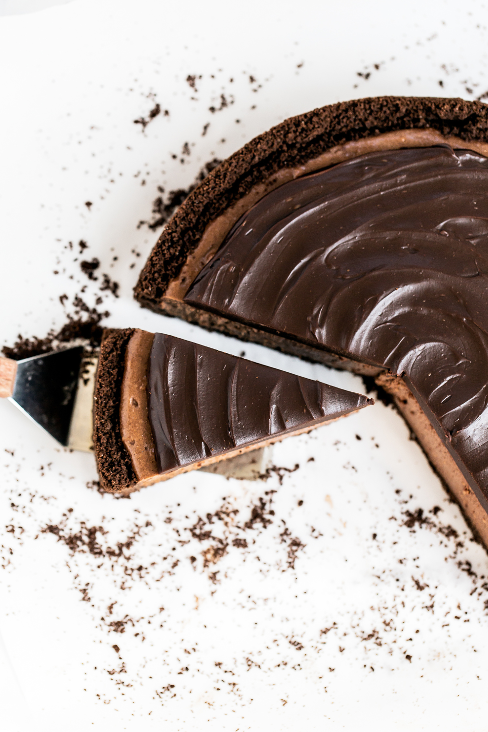 a slice being cut from the death by chocolate cheesecake