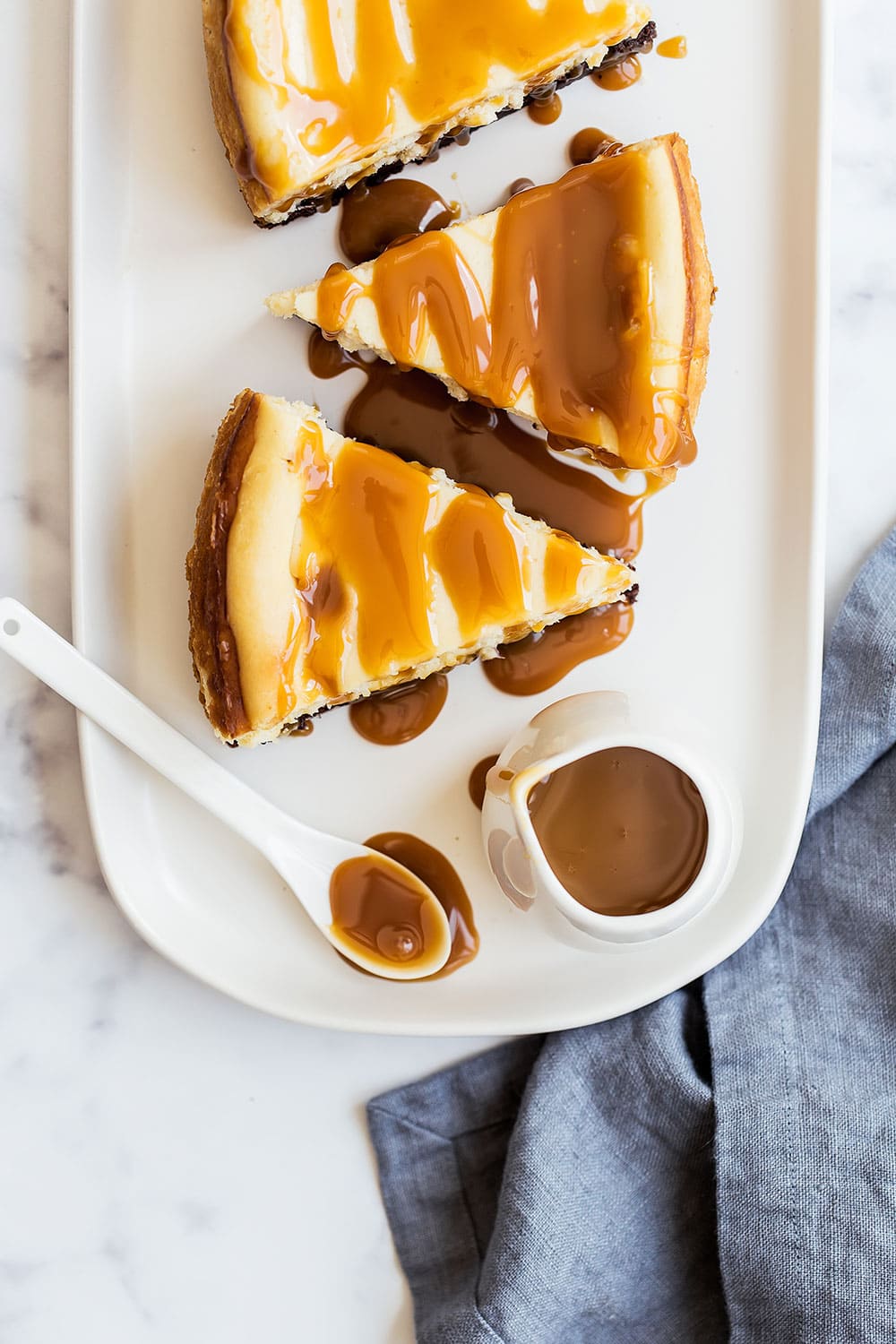 Caramel Brownie Cheesecake featured a thick fudgy brownie bottom with a luscious layer of creamy vanilla cheesecake all topped with salted caramel sauce. Every bite is heaven!