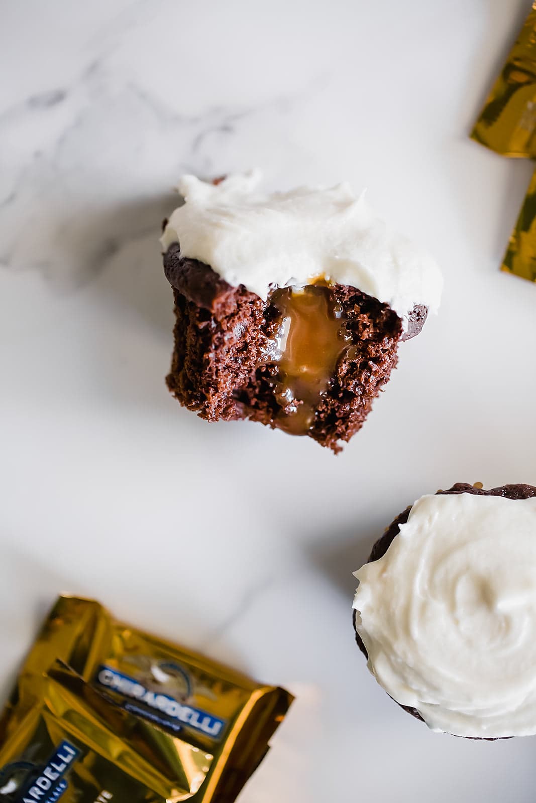 Caramel Stuffed Chocolate Cupcakes feature a super moist and tender chocolate cupcake filled with luscious caramel sauce and topped with vanilla buttercream.