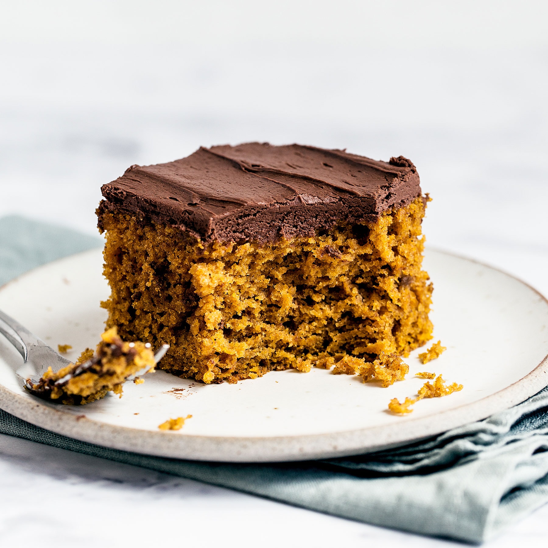 Easy Pumpkin Cake with Whipped Ganache features a super simple spiced pumpkin sour cream cake layer topped with creamy and light whipped chocolate ganache for a quick fall treat perfect for any party or craving!