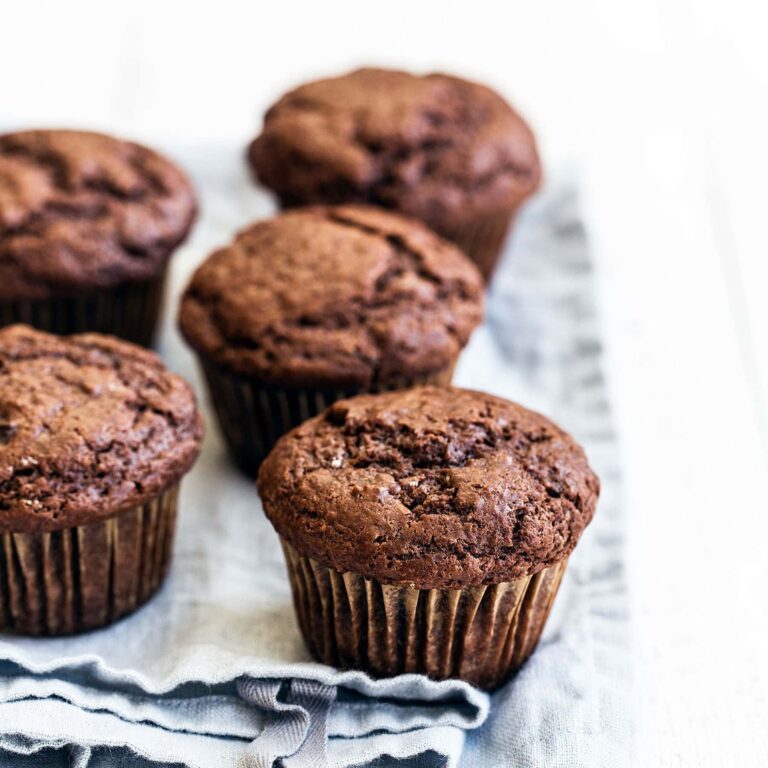 Moist and tender Double Chocolate Muffins feature a brown sugar cocoa muffin studded with gooey chocolate chunks for the ultimate easy treat!