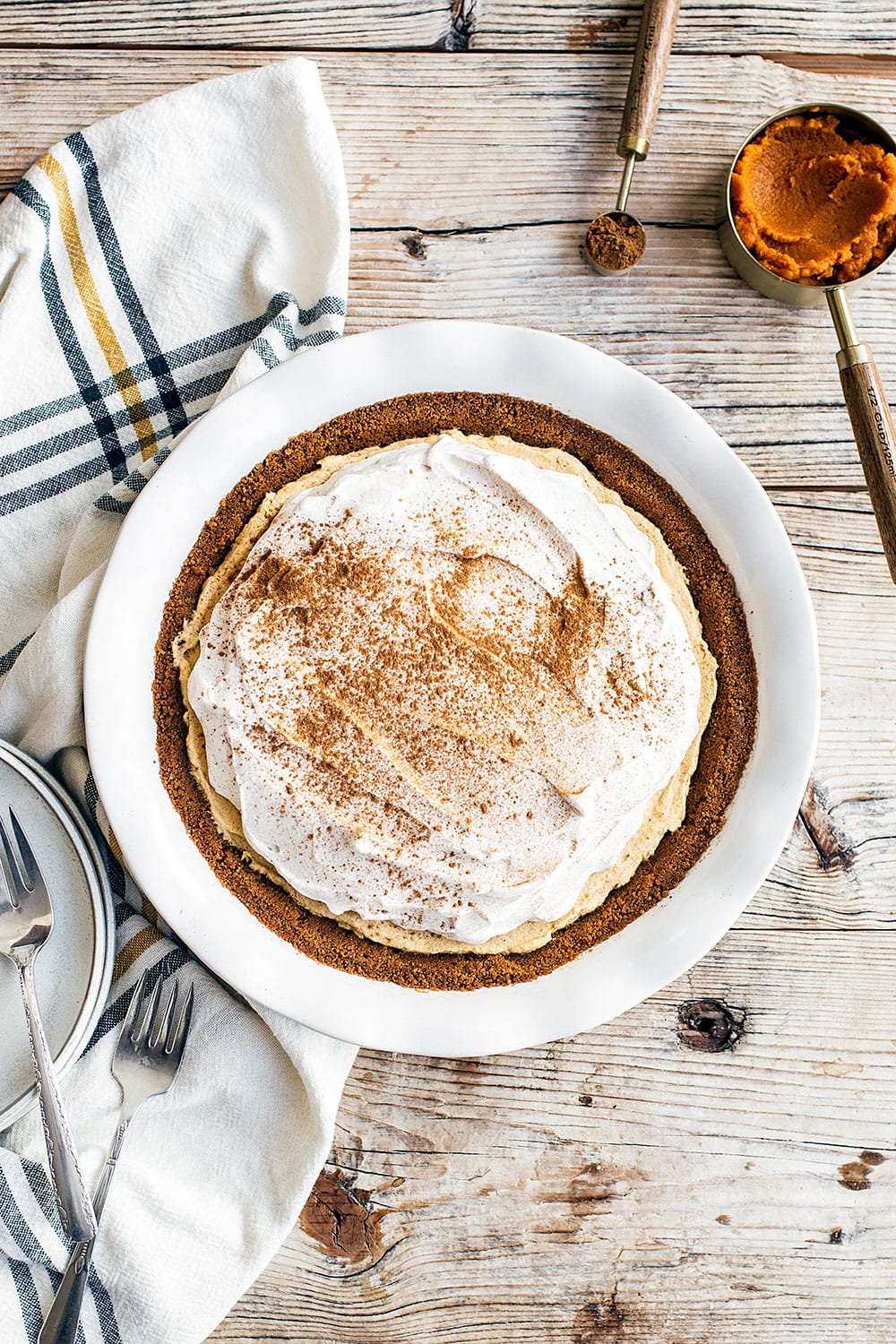 No Bake Pumpkin Mousse Pie features a thick Biscoff cookie crust filled with homemade pumpkin spice mousse and topped with fresh whipped cream. It’s the ultimate easy pumpkin pie for Thanksgiving!