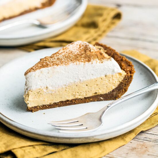 No Bake Pumpkin Mousse Pie features a thick Biscoff cookie crust filled with homemade pumpkin spice mousse and topped with fresh whipped cream. It’s the ultimate easy pumpkin pie for Thanksgiving!