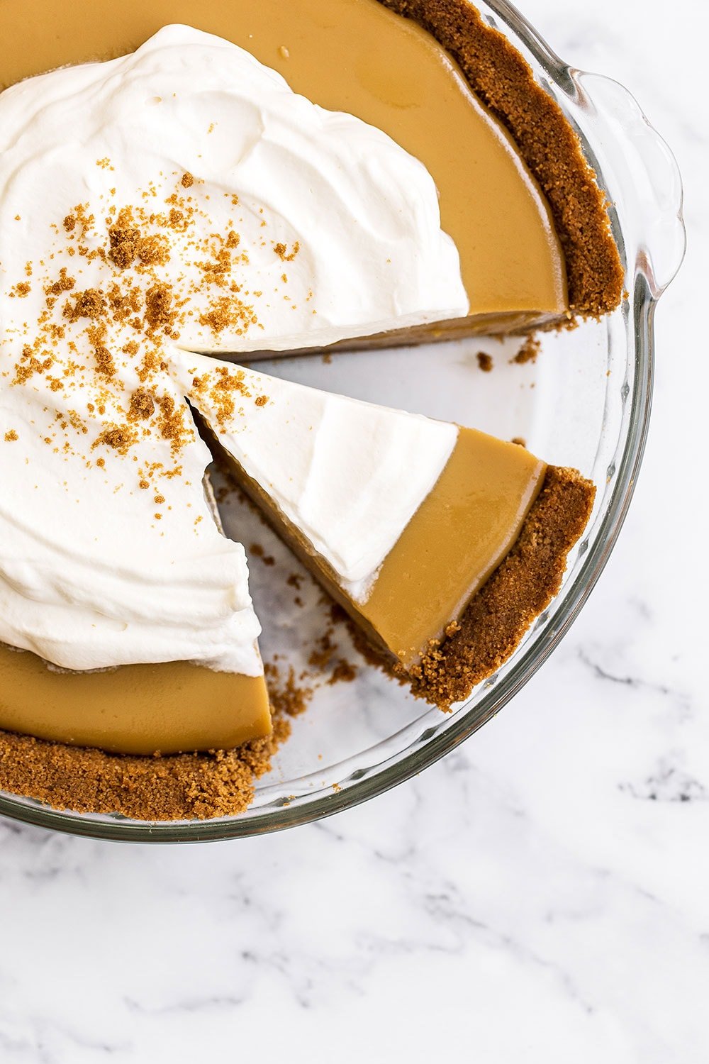 Butterscotch Pie is made with an easy spiced Biscoff cookie crust, homemade butterscotch pudding filling, and is topped with creamy whipped cream. Perfect fall treat!