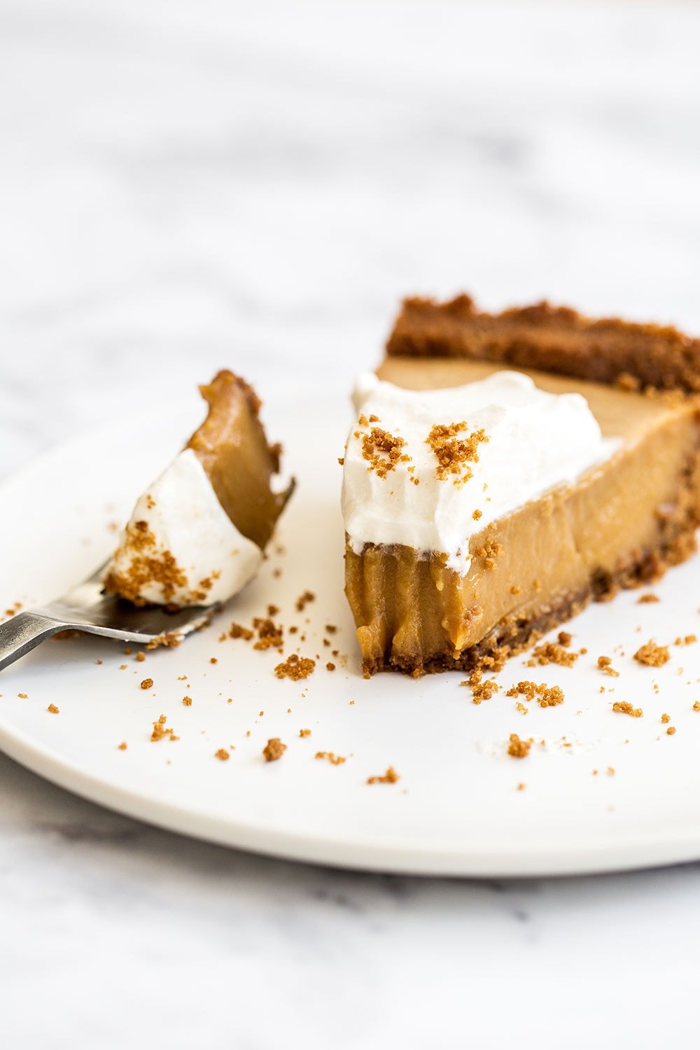 Butterscotch Pie is made with an easy spiced Biscoff cookie crust, homemade butterscotch pudding filling, and is topped with creamy whipped cream. Perfect fall treat!