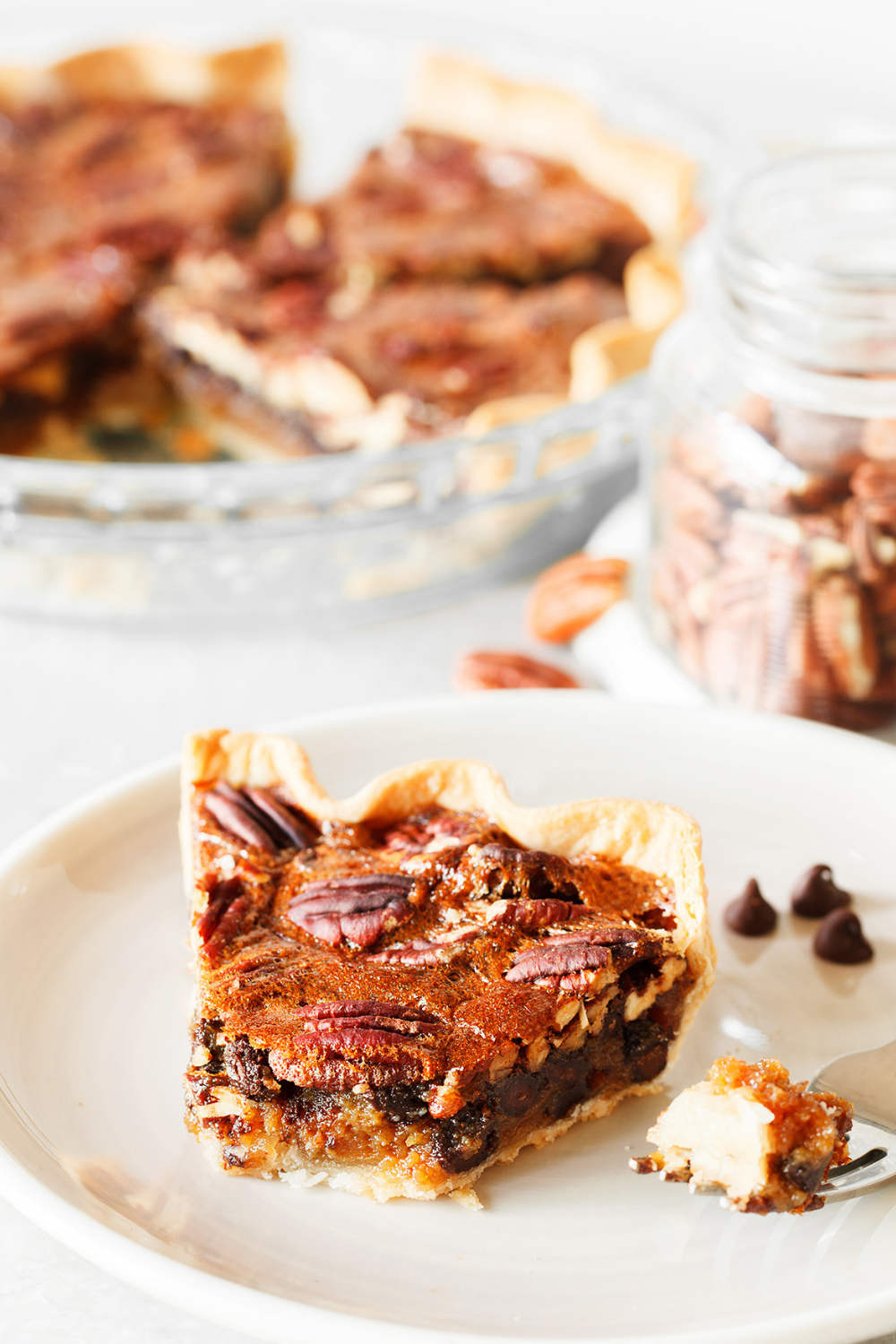 a large slice of chocolate pecan pie on a plate, ready for serving