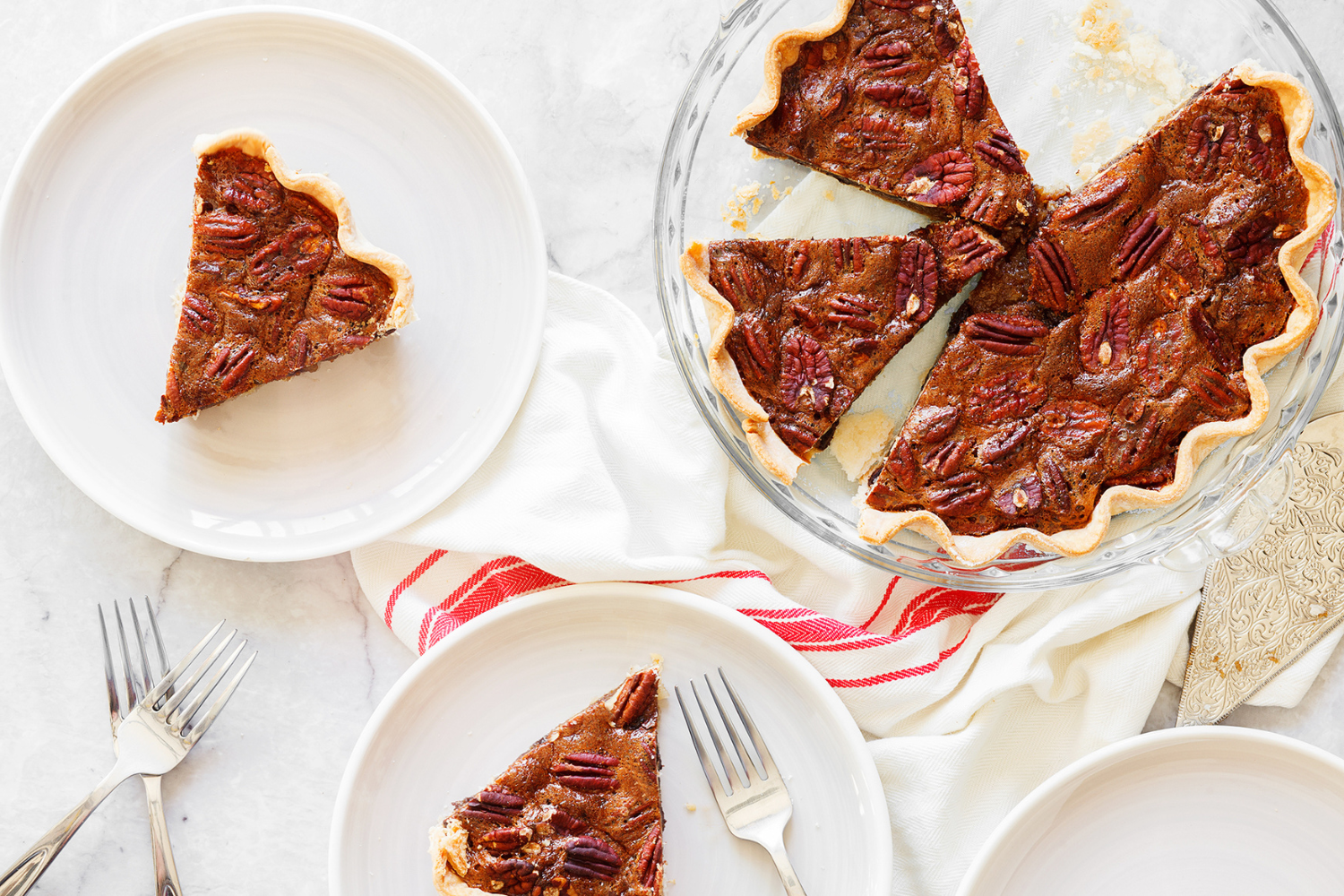 slices of chocolate pecan pie being served onto plates