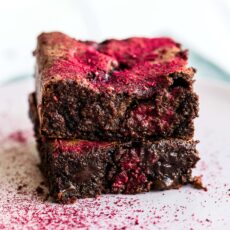 This Raspberry Brownie Recipe is ultra rich and fudgy with gooey chocolate chunks and fresh raspberries studded throughout. A dusting of freeze dried strawberries makes them absolutely beautiful and flavorful!
