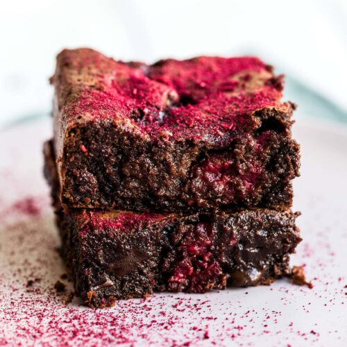This Raspberry Brownie Recipe is ultra rich and fudgy with gooey chocolate chunks and fresh raspberries studded throughout. A dusting of freeze dried strawberries makes them absolutely beautiful and flavorful!