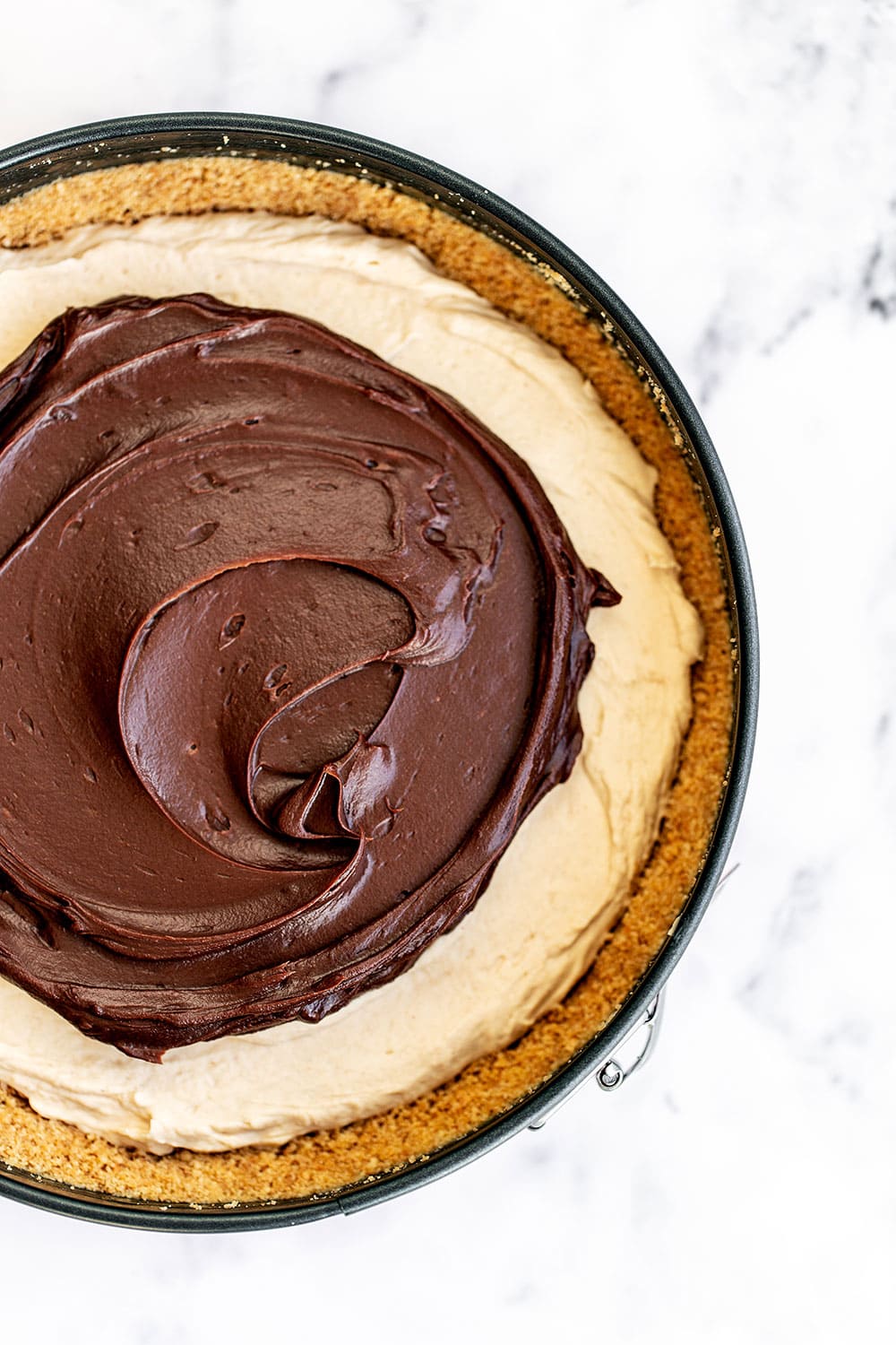 Top of entire no-bake peanut butter cheesecake with chocolate ganache spread over