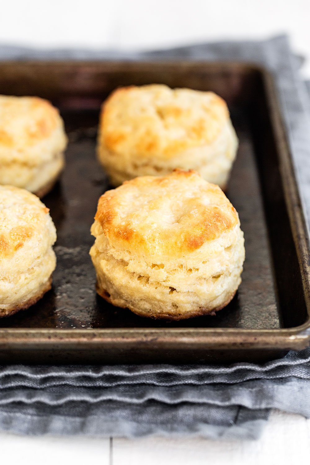 Tray of baked golden brown buttermilk biscuits