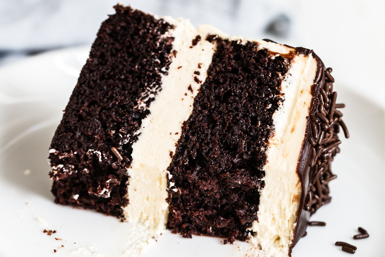 a slice of Guinness Chocolate Cake with Irish Buttercream on a plate, ready to serve.