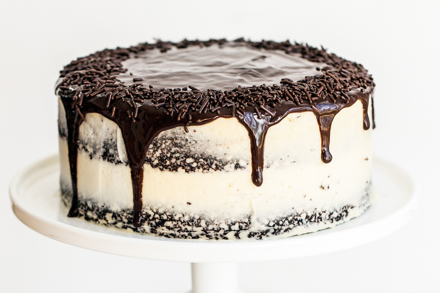 the whole Guinness Chocolate Cake with Irish Buttercream with ganache drip, on a cake stand.