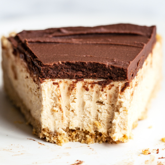 slice of creamy no-bake cheesecake, packed with peanut butter and topped with chocolate