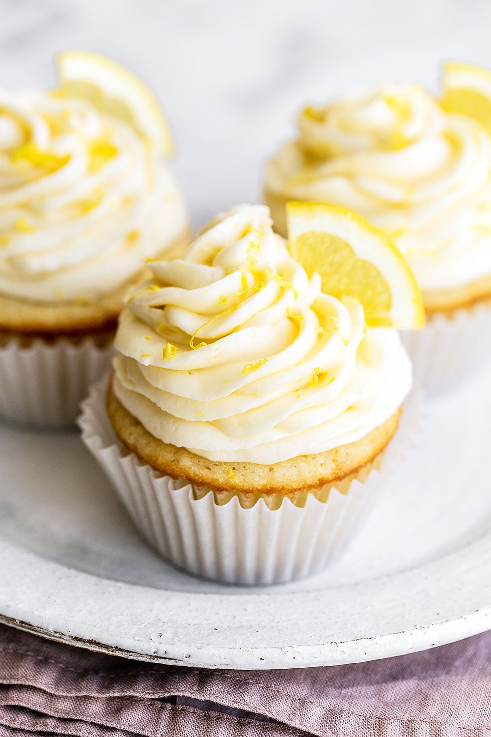 three lemon cupcakes on a plate - easy to serve!