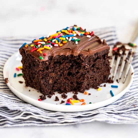 Piece of sheet cake on a plate with bite taken out