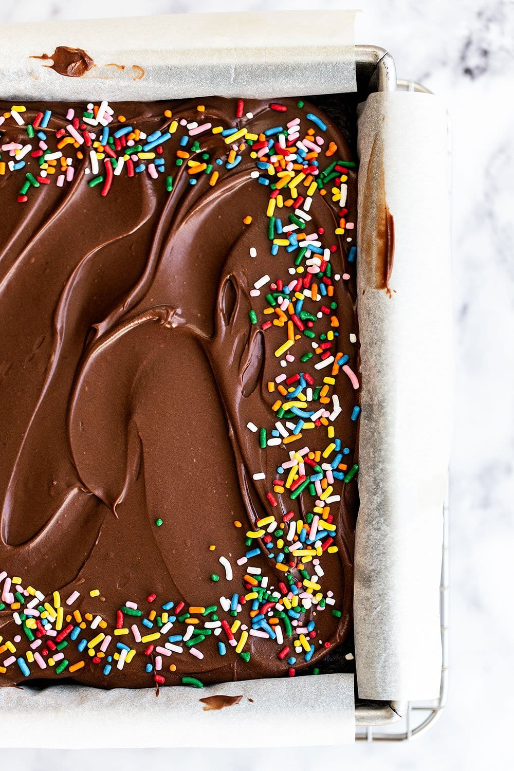 Overhead view of cake with frosting and sprinkles on top