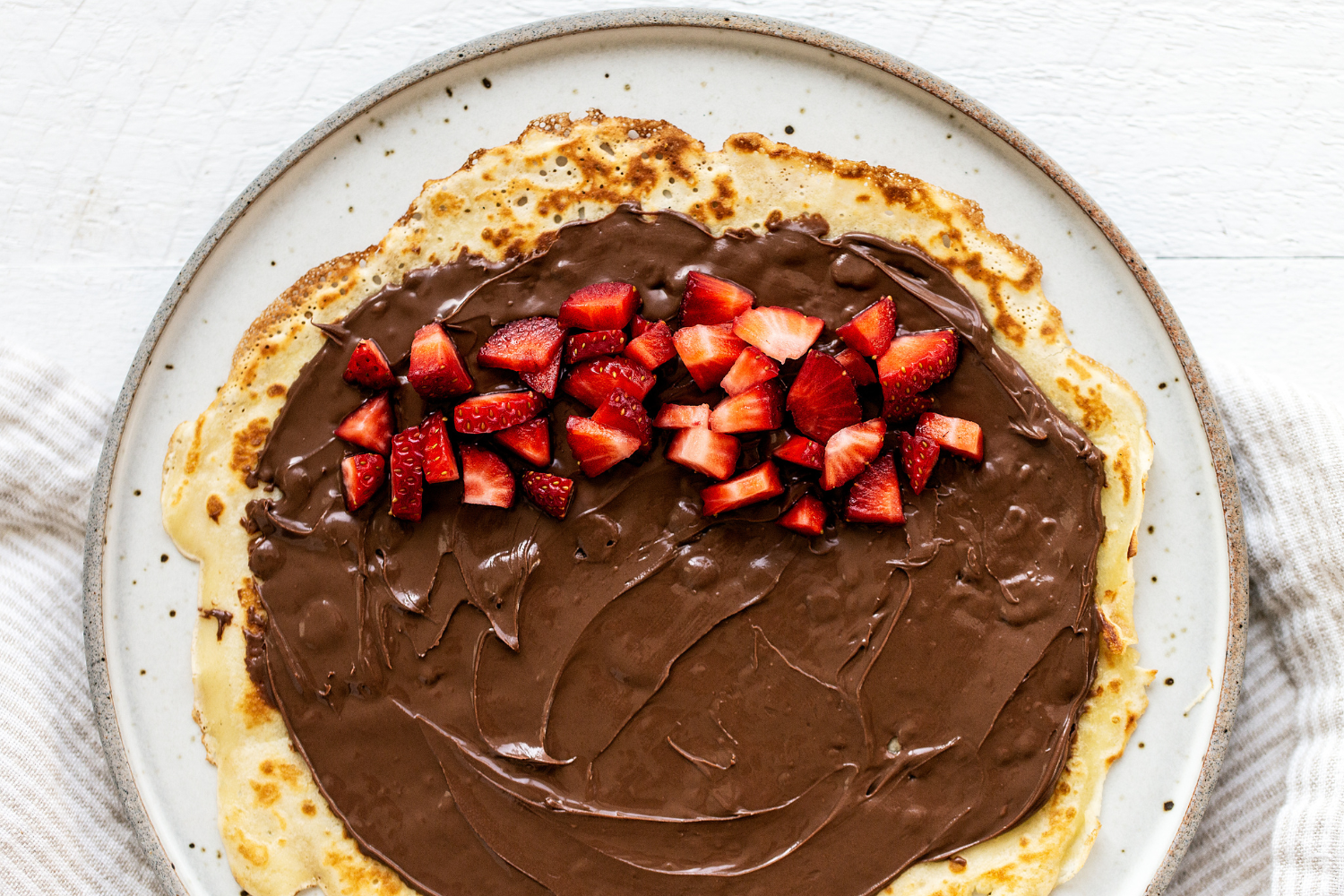 filled with chocolate and fresh strawberries, ready to roll up and serve.