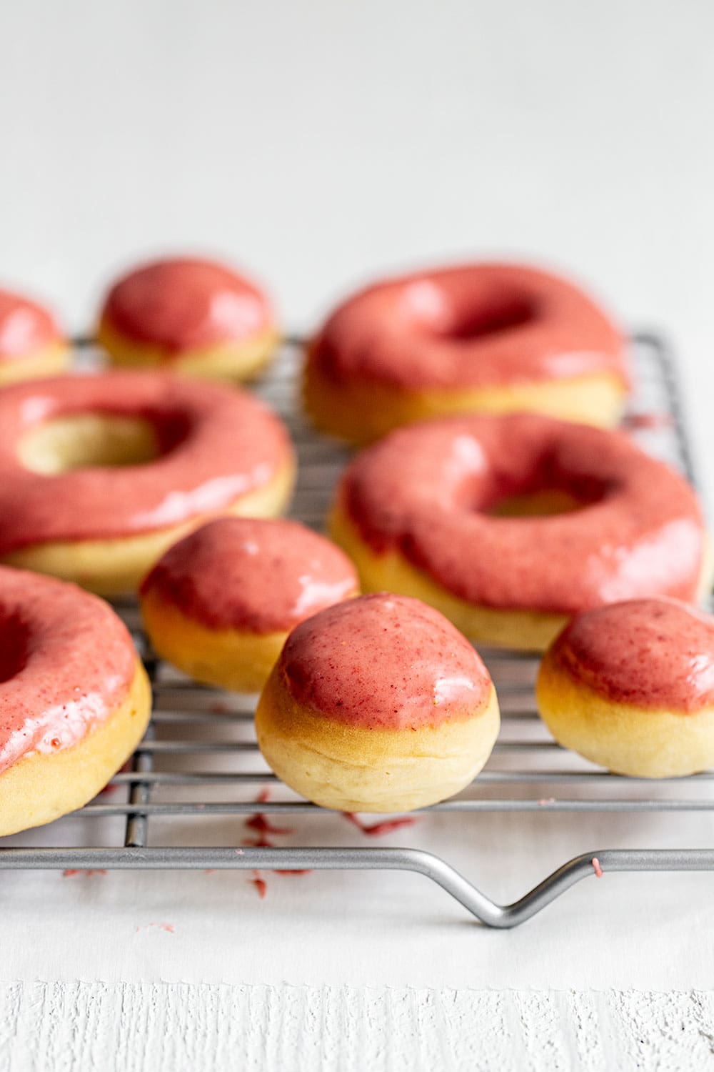 Freshly glazed doughnuts on a rack