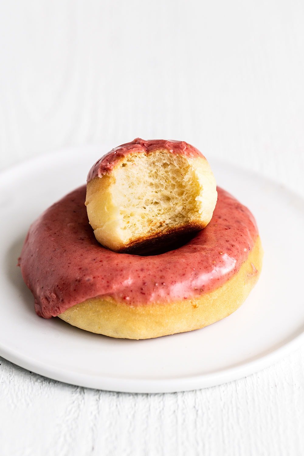 Doughnut on a plate with a half eaten doughnut hole. These are a perfect Easter dessert or Easter brunch option. 