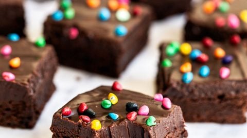 an array of Cosmic brownies, with the front brownie with a bite taken out.