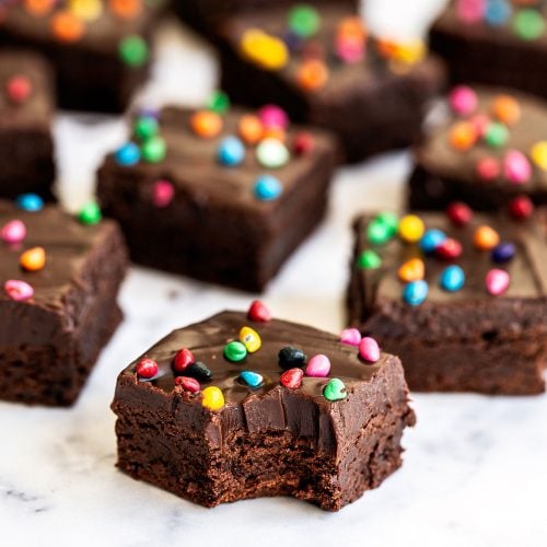 an array of Cosmic brownies, with the front brownie with a bite taken out.