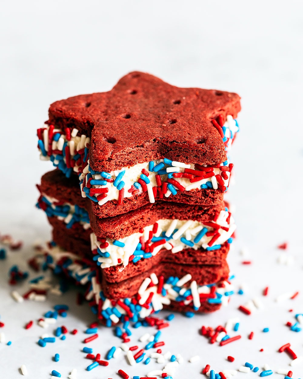 Stack of red velvet ice cream sandwiches with sprinkles