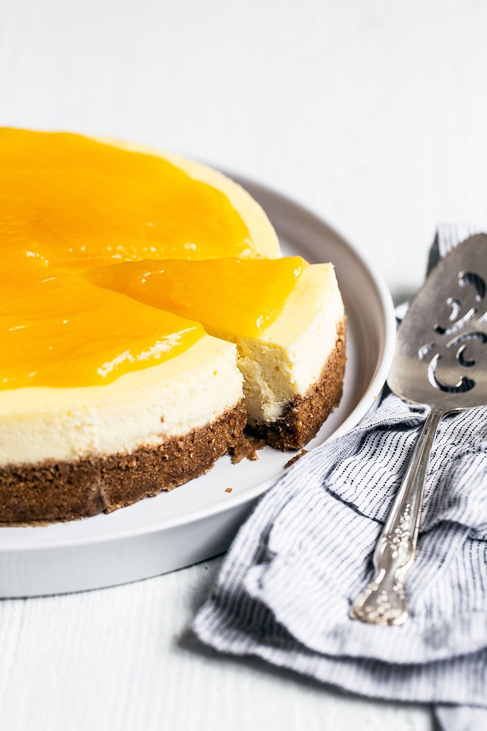 Lemon cheesecake on a platter with piece sliced for serving on Easter Sunday