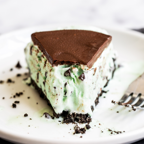 a slice of mint chocolate chip ice cream pie on a plate with a fork.